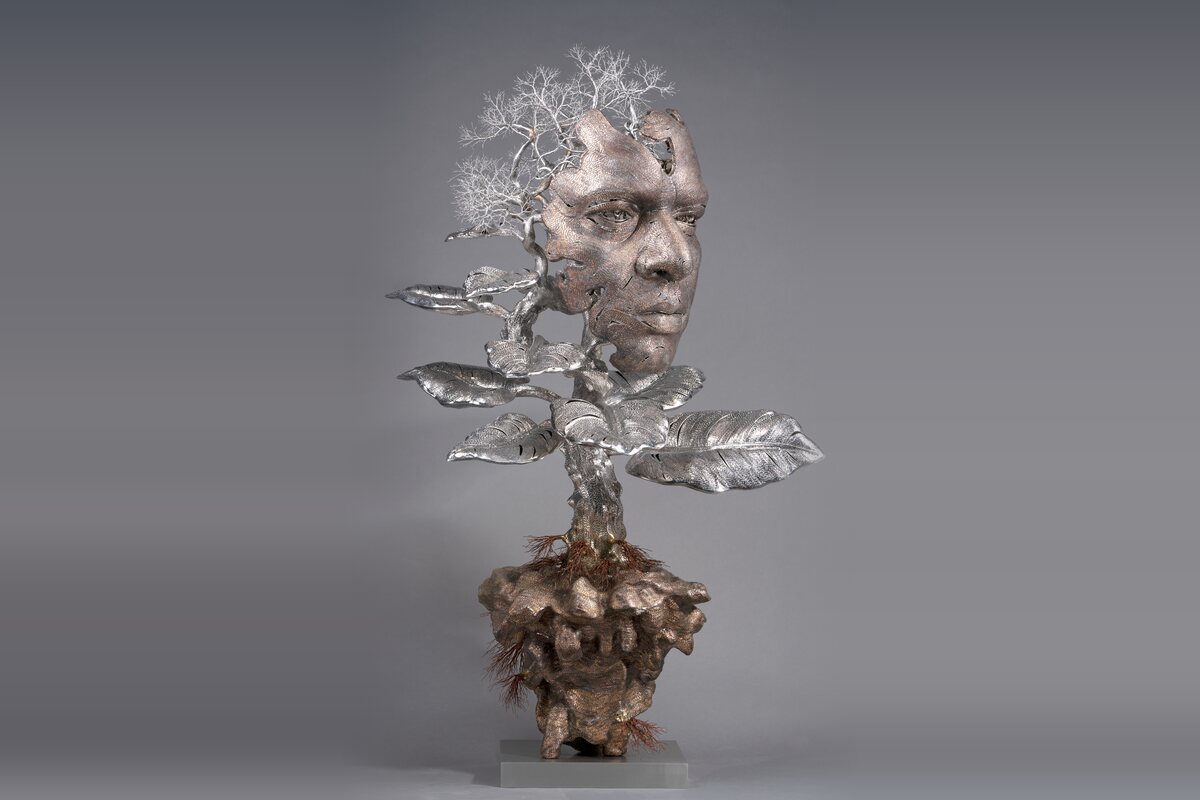 I Am Within You (2020) by Dhananjay Singh, a wire sculpture of a face merging into a tree